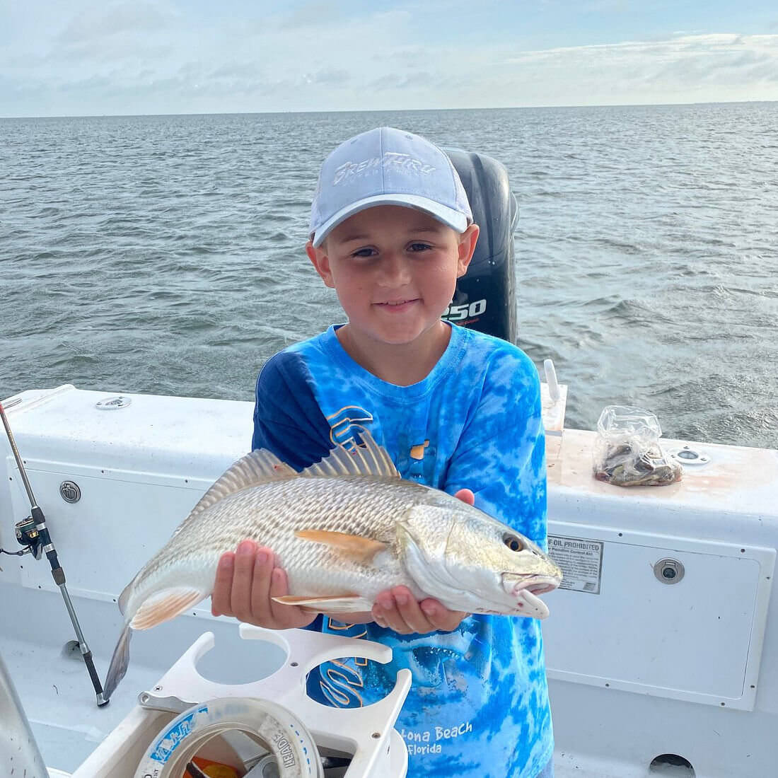 Young angler showing off nice drum on family friendly Misspuitty charter.